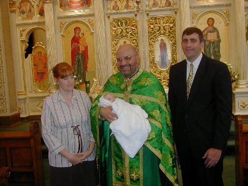 Father Ron's turn to hold Anna.