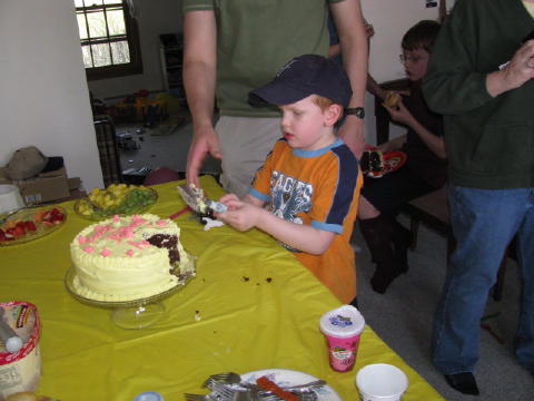 Michael cuts his piece of cake.