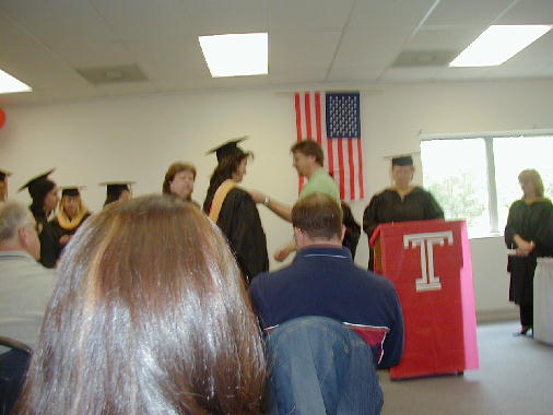 Frank helps Cathy with her hood.