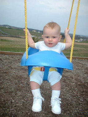 Michael enjoys a sunny day on his swing.