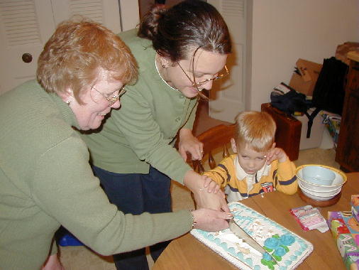 All the birthday kids cut the cake.