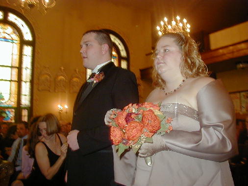 The wedding  party begins to walk up the aisle.